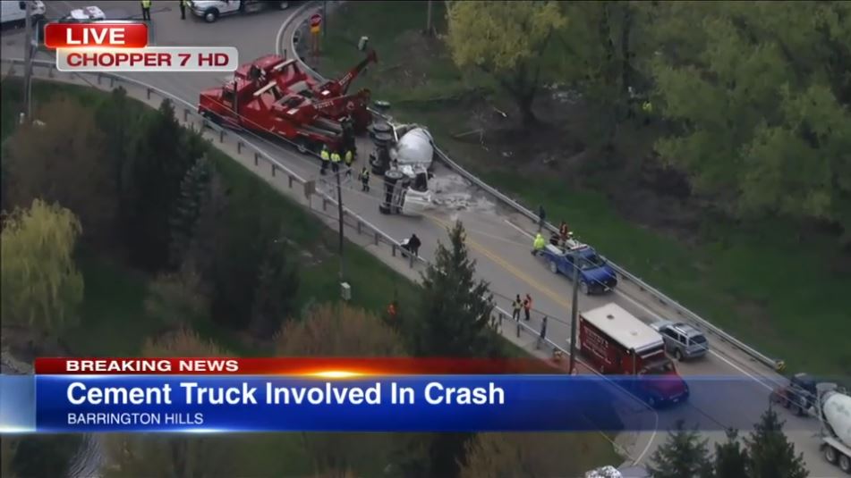 Multiple news outlets report, “Full cement truck falls over in